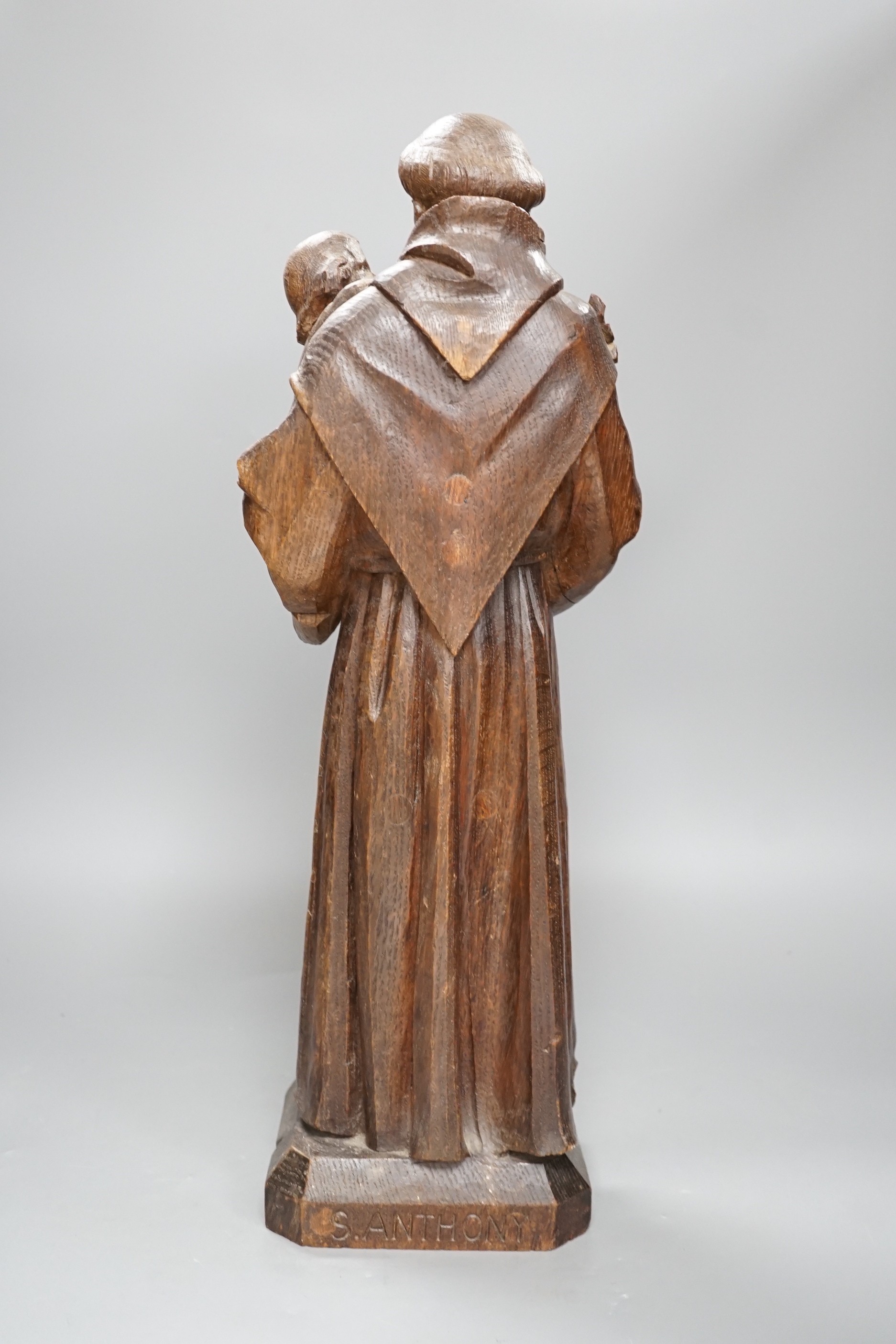 An early 20th century carved oak figure of St Anthony, 51cm